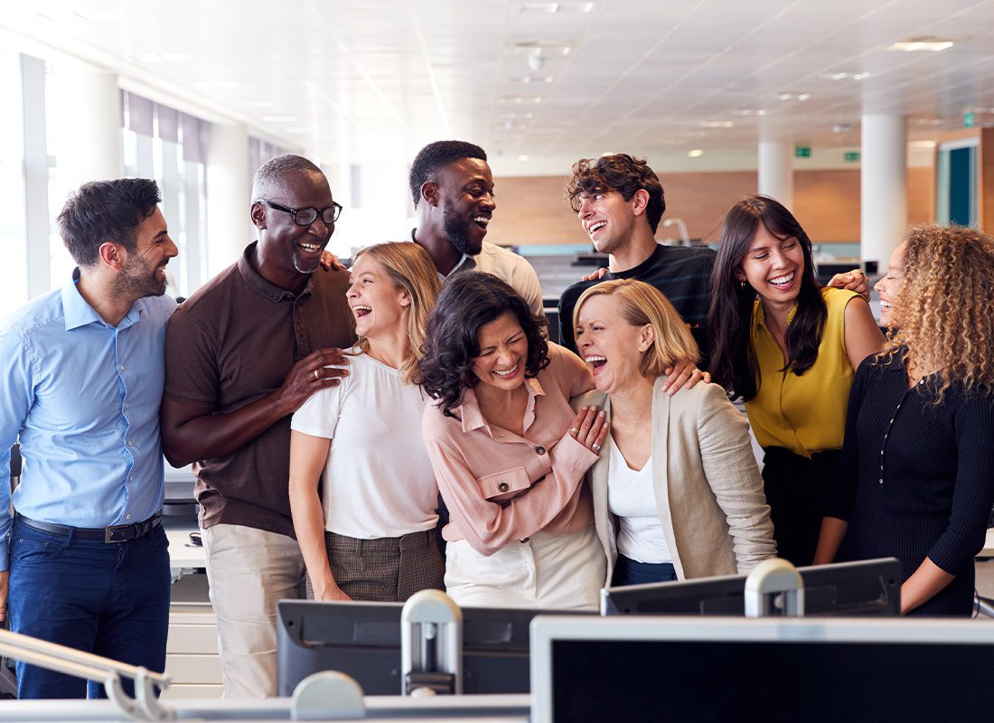 About Our Agency - Happy Business Team Laughing Together and Working in a Modern Office